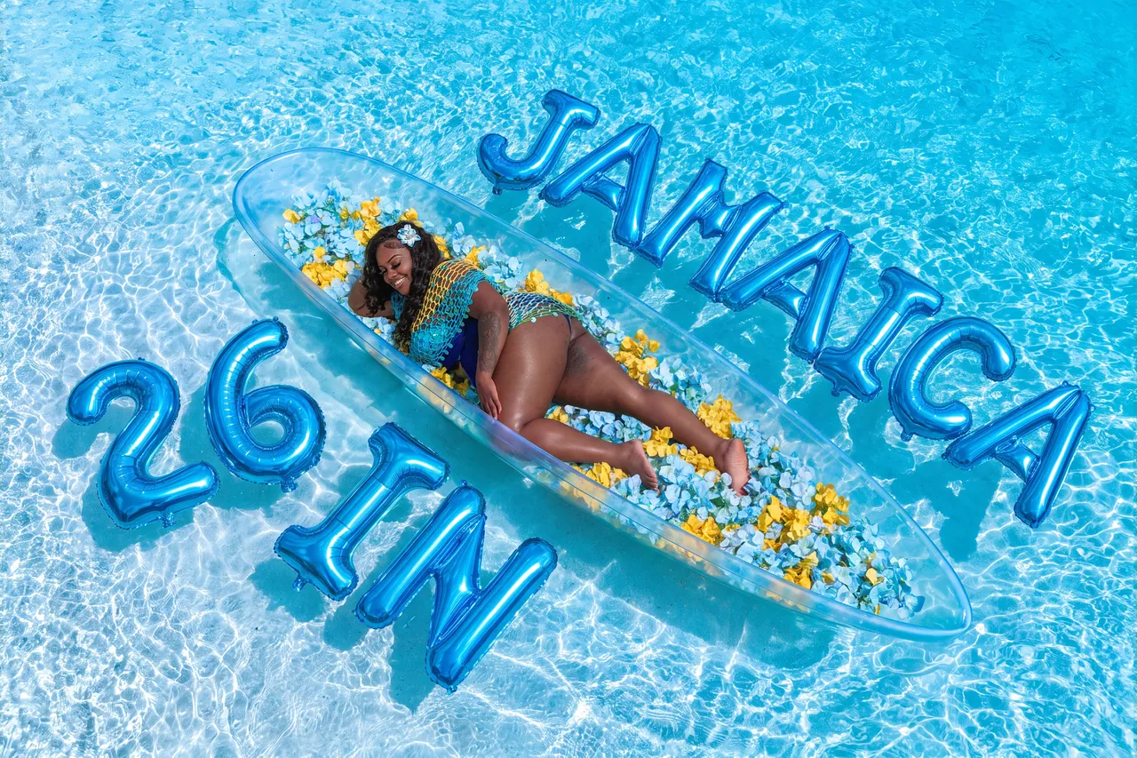 Blue Jamaica birthday balloons and yellow flowers surrounding a clear-kayak portrait