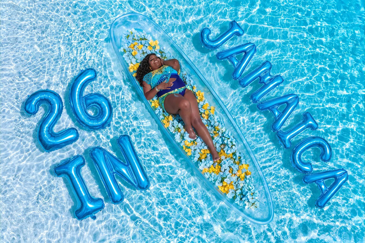 Aerial birthday portrait with blue Jamaica balloons and a yellow-flower clear kayak